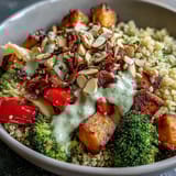 Colorful roasted vegetables, black beans, and crunchy almonds top this wholesome Meal Prep Week-Long Power Bowl ready for storage.