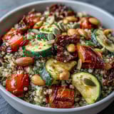 Close-up of a colorful Veggie and Quinoa Power Bowl featuring fluffy quinoa, black beans, and caramelized veggies in a lemon dressing.