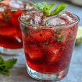 Refreshing Hibiscus Strawberry Lemonade, perfect for festive gatherings with fresh fruit.