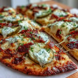 Golden Pickle Pizza Flatbread hot from oven, drizzled with zesty ranch.