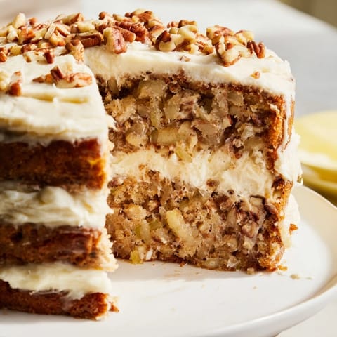 Golden-layered Hummingbird Cake, freshly baked, features ripe bananas and pineapple, ready to serve.