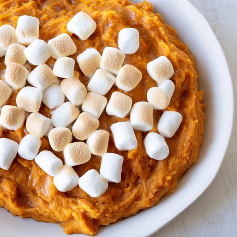 Golden sweet potato casserole topped with toasted marshmallows, a classic holiday side dish.