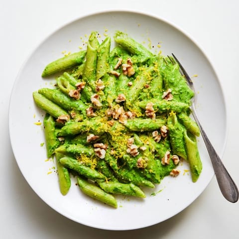 A close-up of Creamy Spinach Walnut Pasta, showcasing the velvety spinach sauce clinging to each strand, with toasted walnuts adding texture.