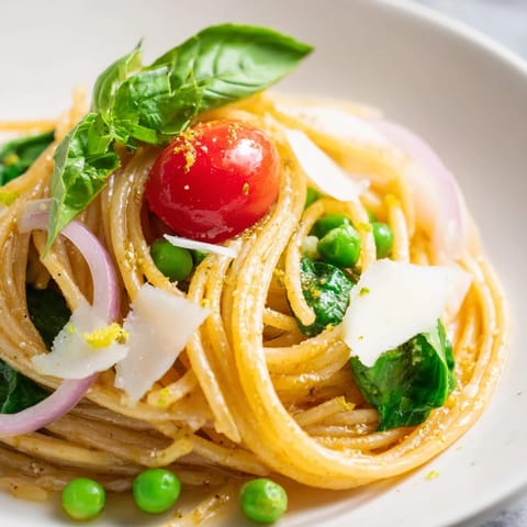 Bright cherry tomatoes and wilted spinach create a vibrant, vegetable-packed main dish perfect for weeknight dinners.  