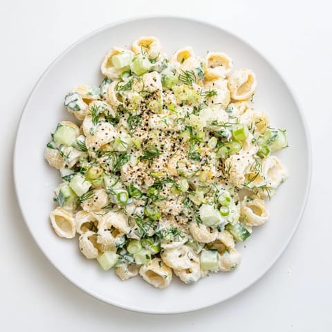 Tossing the Cucumber Crunch Pasta Salad, tiny shells are coated in creamy dill dressing and studded with fresh cucumber and green onions.  