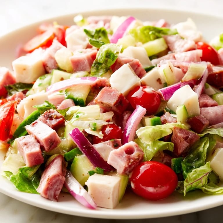 A vibrant bowl of Italian Deli Chopped Chicken Salad with colorful chopped vegetables, salami, and chicken, ready to serve as a hearty main dish.