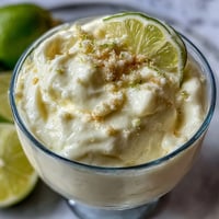 Zesty lemon mousse with buttery shortbread crumble in elegant dessert cups, perfect for spring gatherings.