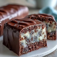 Festive pastel chocolate bark with Cadbury eggs, featuring swirls of colorful candy melts and crunchy candy toppings.